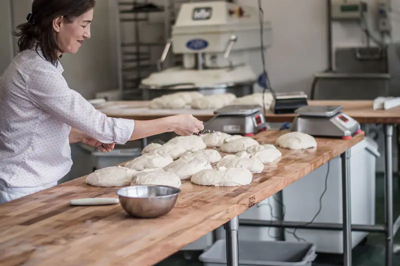 Woman prepping bread to bake